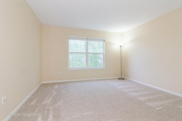 2210 Surrey St, Sycamore, IL 60178 - carpeted empty room with baseboards