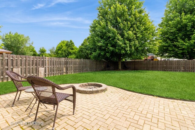2210 Surrey St, Sycamore, IL 60178 - fenced backyard featuring a fire pit and a patio area