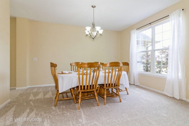 2210 Surrey St, Sycamore, IL 60178 - carpeted dining area with a chandelier and baseboards