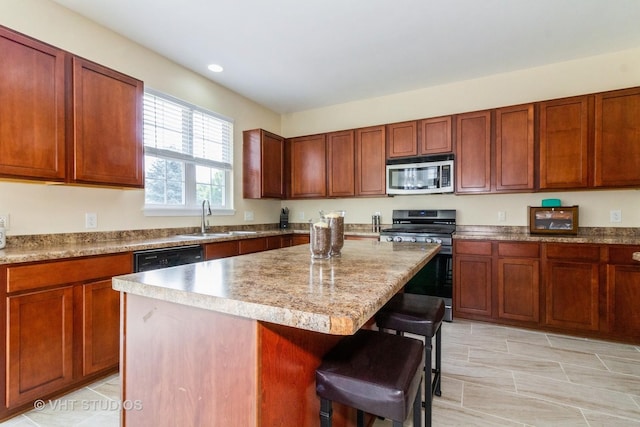2210 Surrey St, Sycamore, IL 60178 - kitchen featuring appliances with stainless steel finishes, a breakfast bar area, a kitchen island, and recessed lighting