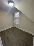 4514 S Honore St, Chicago, IL 60609 - additional living space with baseboards and dark wood-type flooring