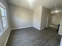 4514 S Honore St, Chicago, IL 60609 - empty room featuring baseboards, dark wood-style floors, and healthy amount of natural light