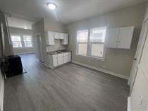 4514 S Honore St, Chicago, IL 60609 - kitchen with white cabinets, wood finished floors, and baseboards