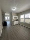 4514 S Honore St, Chicago, IL 60609 - unfurnished living room with wood finished floors and baseboards