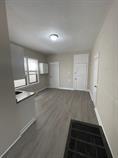 4514 S Honore St, Chicago, IL 60609 - unfurnished living room featuring wood finished floors and baseboards