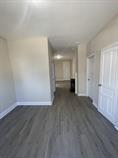 4514 S Honore St, Chicago, IL 60609 - unfurnished living room with baseboards and wood finished floors