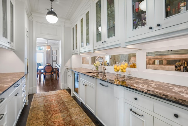 2123 N Bissell St, Chicago, IL 60614 - bar area with a sink, ornamental molding, dark wood-style floors, and pendant lighting