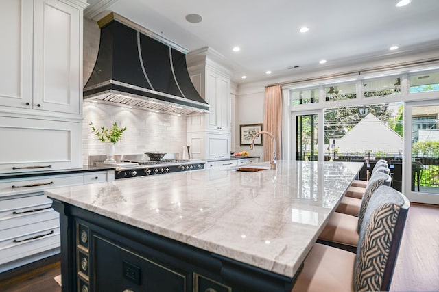 2123 N Bissell St, Chicago, IL 60614 - kitchen with premium range hood, healthy amount of natural light, decorative backsplash, white cabinets, and recessed lighting
