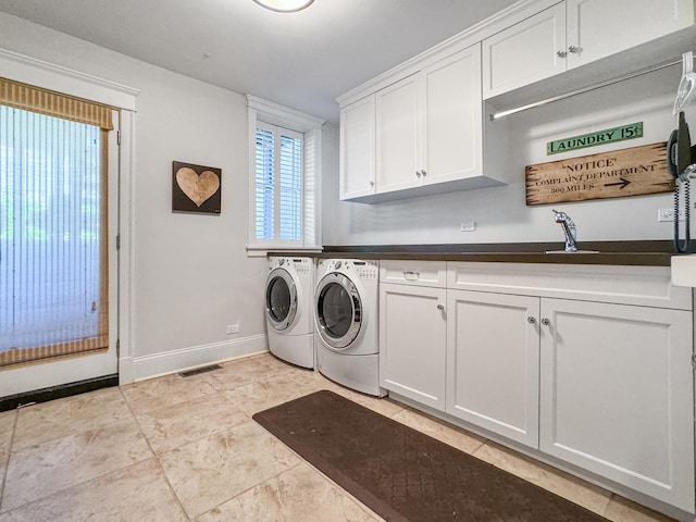 2123 N Bissell St, Chicago, IL 60614 - laundry room with cabinet space, independent washer and dryer, baseboards, and light tile patterned floors