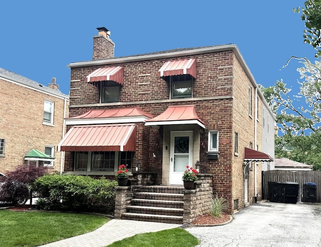10043 S Artesian Ave, Chicago, IL 60655 - view of front of house featuring a chimney, brick siding, a standing seam roof, and a metal roof