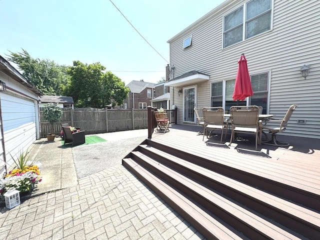 10043 S Artesian Ave, Chicago, IL 60655 - fenced backyard featuring outdoor dining area, a patio area, a wooden deck, and a garage