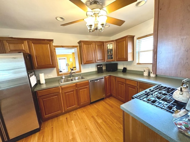 10043 S Artesian Ave, Chicago, IL 60655 - kitchen featuring appliances with stainless steel finishes, brown cabinets, light wood-style floors, and a ceiling fan