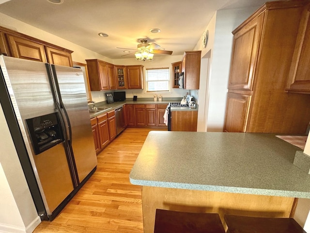 10043 S Artesian Ave, Chicago, IL 60655 - kitchen with stainless steel appliances, light wood finished floors, brown cabinetry, ceiling fan, and glass insert cabinets