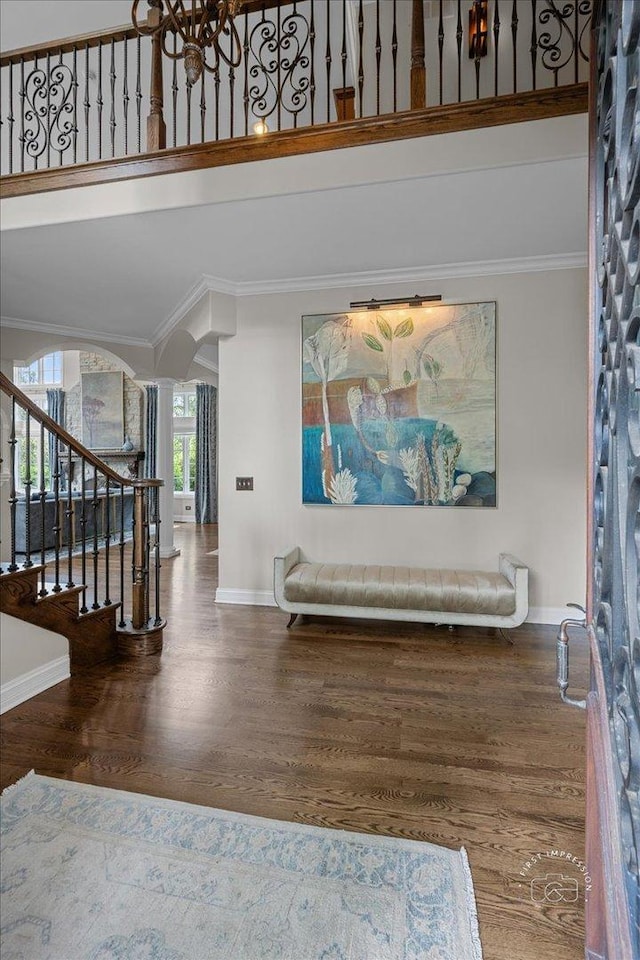 1088 Dunstan Rd, Geneva, IL 60134 - entryway with crown molding, wood finished floors, arched walkways, stairway, and a chandelier