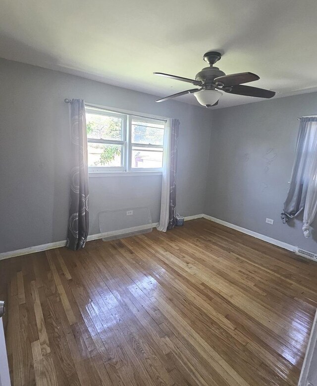 15210 Evers St, Dolton, IL 60419 - empty room featuring wood finished floors, a ceiling fan, and baseboards