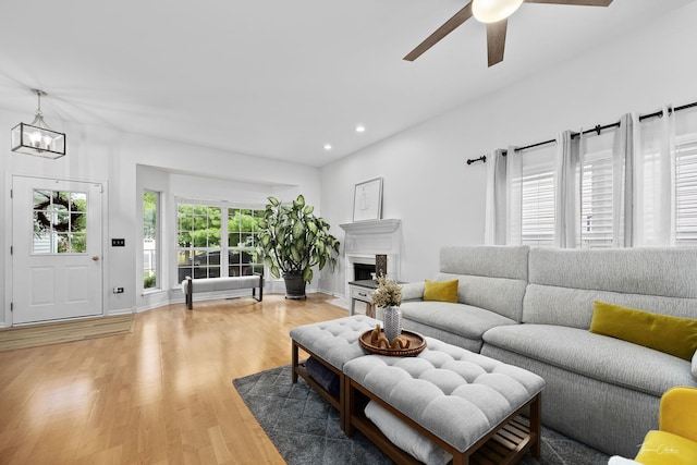 1910 Baldwin Way, Bolingbrook, IL 60490 - living area featuring light wood-type flooring, recessed lighting, a ceiling fan, a chandelier, and a fireplace