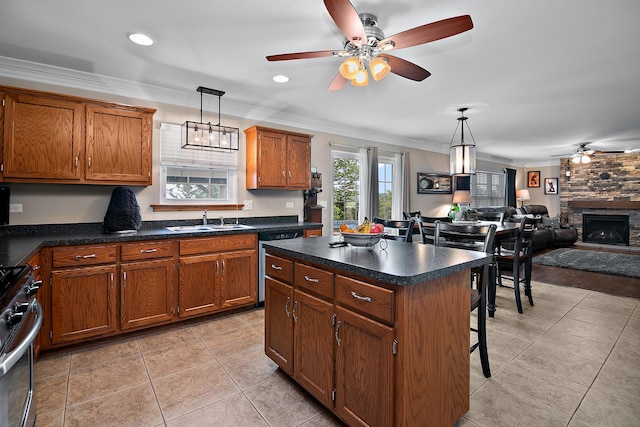 24450 Shawnee Ln, Manhattan, IL 60442 - kitchen featuring appliances with stainless steel finishes, a ceiling fan, ornamental molding, brown cabinetry, and a kitchen bar