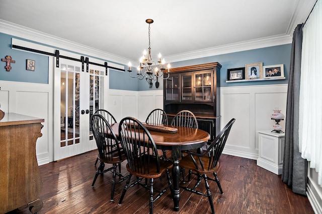 24450 Shawnee Ln, Manhattan, IL 60442 - dining room featuring a barn door, a decorative wall, wainscoting, crown molding, and a chandelier