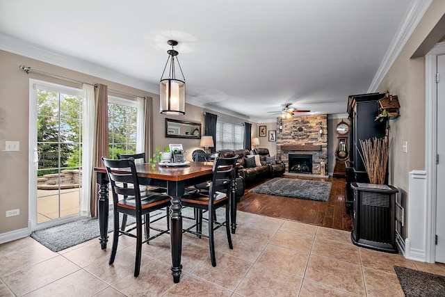 24450 Shawnee Ln, Manhattan, IL 60442 - dining area with crown molding, ceiling fan, a fireplace, and light tile patterned floors