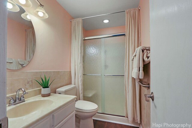4008 W Lillian St, Mchenry, IL 60050 - full bathroom with a stall shower, vanity, tile walls, recessed lighting, and wood finished floors