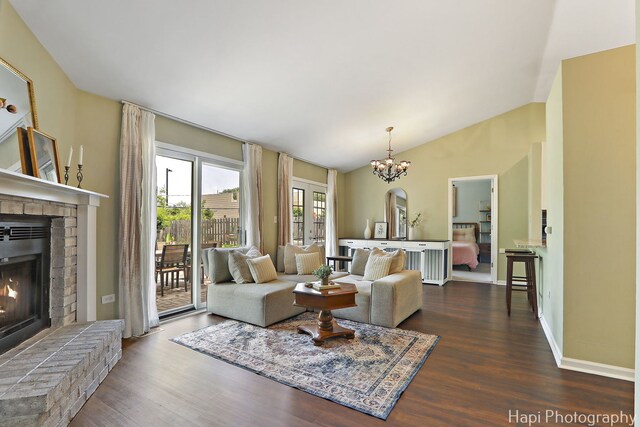 4008 W Lillian St, Mchenry, IL 60050 - living room with a fireplace, wood finished floors, vaulted ceiling, and a chandelier