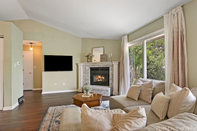 4008 W Lillian St, Mchenry, IL 60050 - living area featuring dark wood-style flooring, vaulted ceiling, and a brick fireplace