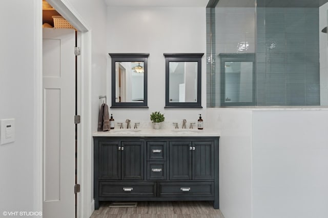 6N142 Riverside Dr, Saint Charles, IL 60175 - bathroom featuring double vanity, wood finished floors, and a tile shower