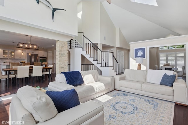 6N142 Riverside Dr, Saint Charles, IL 60175 - living area featuring high vaulted ceiling, wood finished floors, stairs, and decorative columns