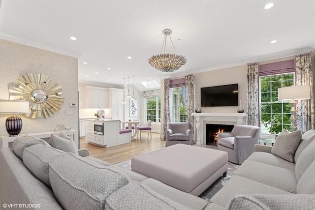 37 Harborside Way, Hawthorn Woods, IL 60047 - living area featuring healthy amount of natural light, light wood-style flooring, recessed lighting, a warm lit fireplace, and ornamental molding
