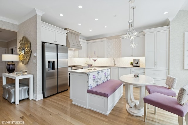 37 Harborside Way, Hawthorn Woods, IL 60047 - kitchen featuring stainless steel fridge, custom range hood, ornamental molding, a center island, and light wood finished floors