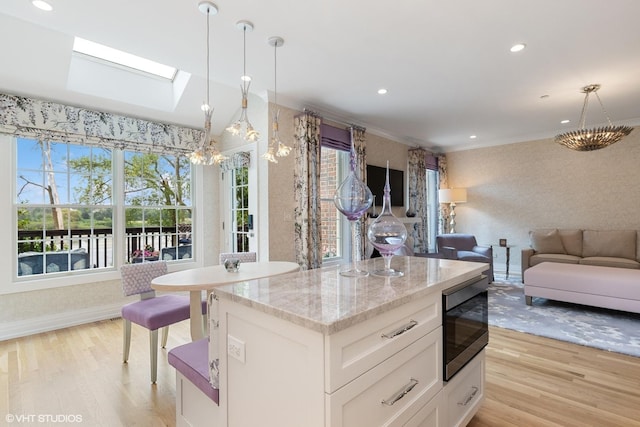 37 Harborside Way, Hawthorn Woods, IL 60047 - kitchen with built in microwave, a skylight, light wood-type flooring, a chandelier, and recessed lighting