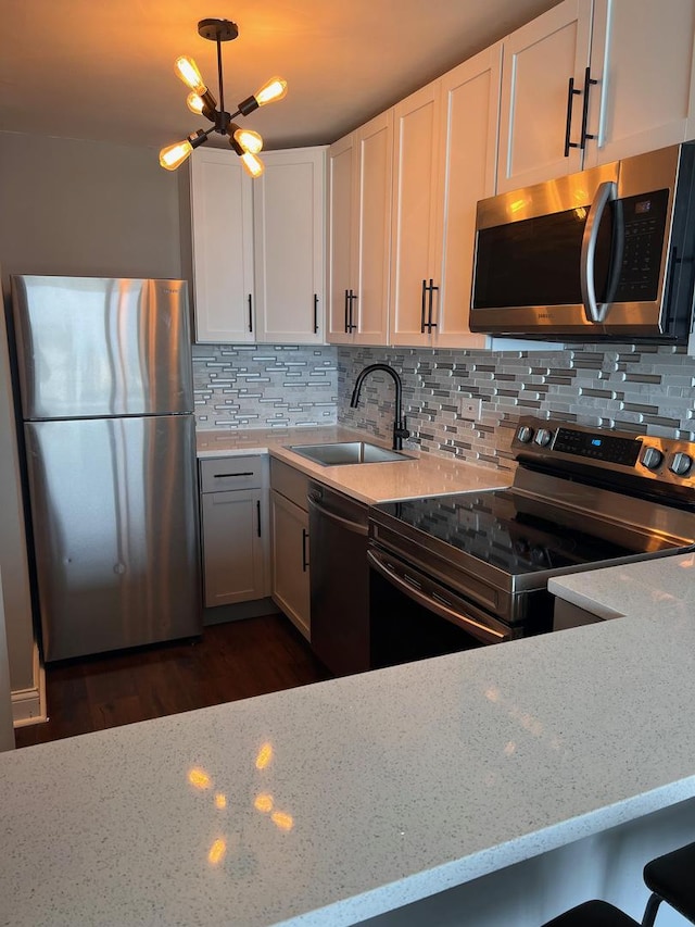 5455 N Sheridan Rd Unit 3409, Chicago, IL 60640 - kitchen with appliances with stainless steel finishes, light stone countertops, decorative backsplash, and white cabinets