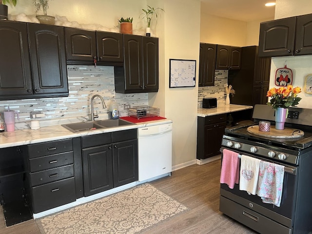 1901 Cora St, Crest Hill, IL 60403 - kitchen with stainless steel range oven, white dishwasher, decorative backsplash, light wood-style flooring, and light countertops
