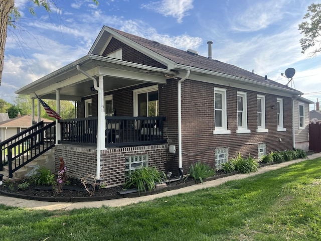1901 Cora St, Crest Hill, IL 60403 - view of home's exterior with a porch, brick siding, a lawn, and roof with shingles