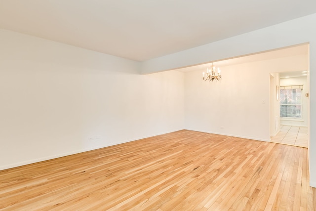 5400 S Hyde Park Blvd Unit 10C, Chicago, IL 60615 - spare room with a chandelier and light wood finished floors