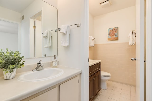 5400 S Hyde Park Blvd Unit 10C, Chicago, IL 60615 - bathroom featuring vanity, tile patterned flooring, tile walls, and a wainscoted wall