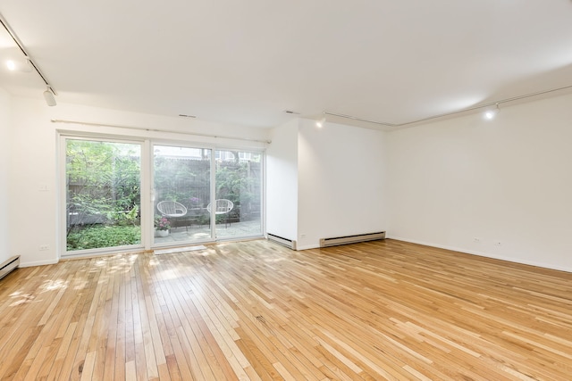 5400 S Hyde Park Blvd Unit 10C, Chicago, IL 60615 - unfurnished room featuring rail lighting, a baseboard radiator, and light wood finished floors