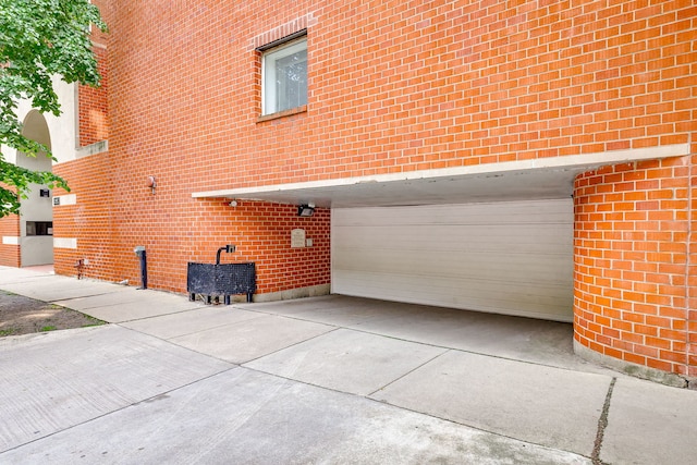 5400 S Hyde Park Blvd Unit 10C, Chicago, IL 60615 - view of side of home with concrete driveway, brick siding, and a garage