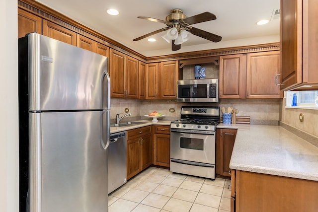 5400 S Hyde Park Blvd Unit 10C, Chicago, IL 60615 - kitchen with stainless steel appliances, brown cabinetry, decorative backsplash, a ceiling fan, and light tile patterned floors