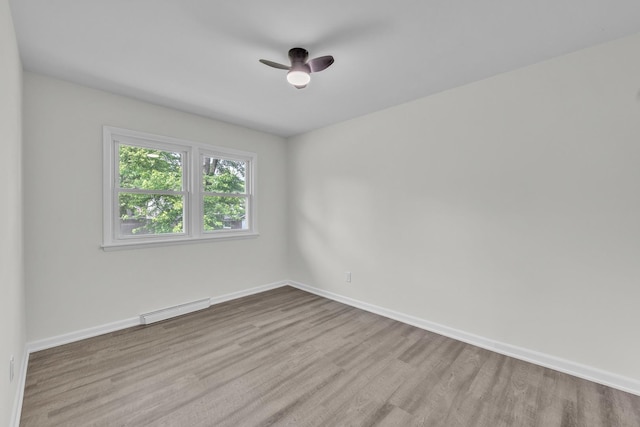 2270 177th St, Lansing, IL 60438 - empty room with baseboard heating, wood finished floors, baseboards, and a ceiling fan