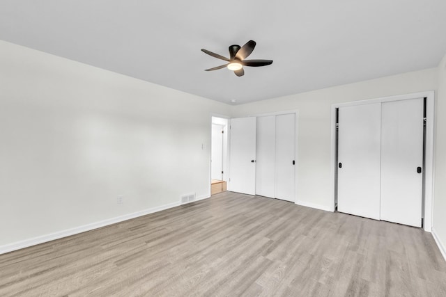 2270 177th St, Lansing, IL 60438 - unfurnished bedroom featuring light wood-type flooring, multiple closets, baseboards, and a ceiling fan