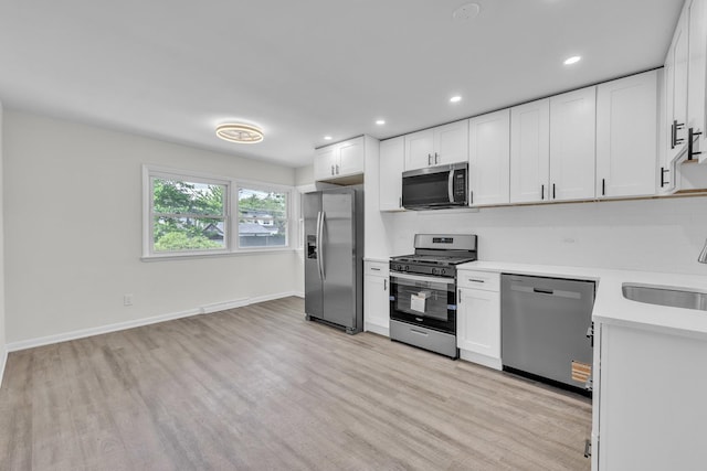 2270 177th St, Lansing, IL 60438 - kitchen with appliances with stainless steel finishes, light countertops, white cabinetry, light wood-type flooring, and recessed lighting