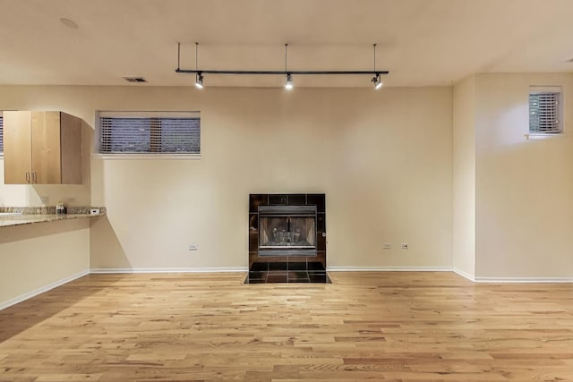 2031 W Evergreen Ave Unit 1W, Chicago, IL 60622 - unfurnished living room featuring track lighting, wood finished floors, and a wood stove