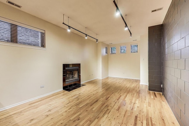 2031 W Evergreen Ave Unit 1W, Chicago, IL 60622 - unfurnished living room featuring light wood-style flooring, track lighting, and a fireplace