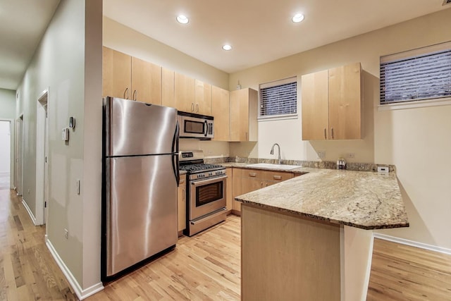 2031 W Evergreen Ave Unit 1W, Chicago, IL 60622 - kitchen with appliances with stainless steel finishes, light brown cabinets, a peninsula, light wood-style flooring, and recessed lighting
