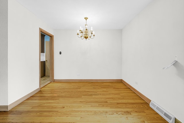10021 Cook Ave, Oak Lawn, IL 60453 - spare room with a chandelier and light wood-type flooring