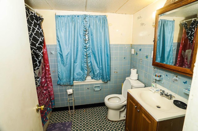 9134 S Justine St, Chicago, IL 60620 - bathroom featuring tile walls, toilet, tile patterned floors, vanity, and a wainscoted wall