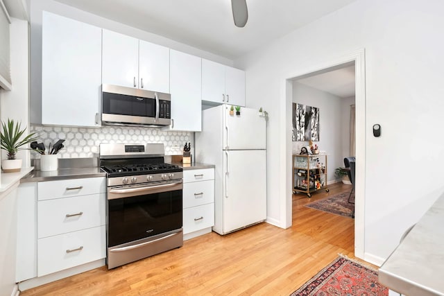 2127 W Pierce Ave Unit 2A, Chicago, IL 60622 - kitchen with appliances with stainless steel finishes, stainless steel countertops, light wood-style floors, and white cabinets