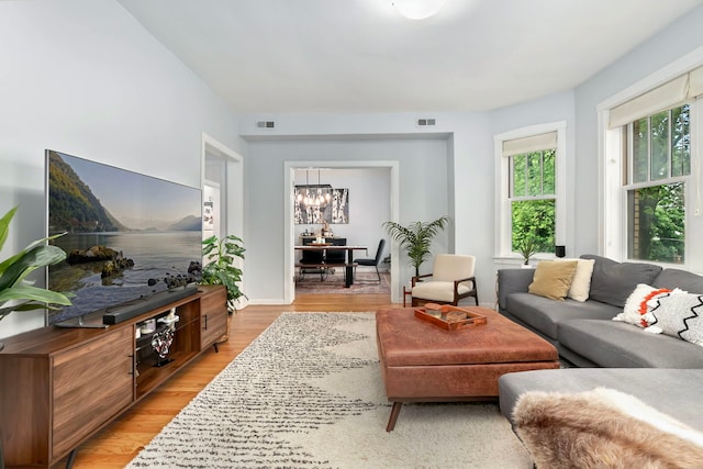 2127 W Pierce Ave Unit 2A, Chicago, IL 60622 - living area with a chandelier and light wood-style flooring