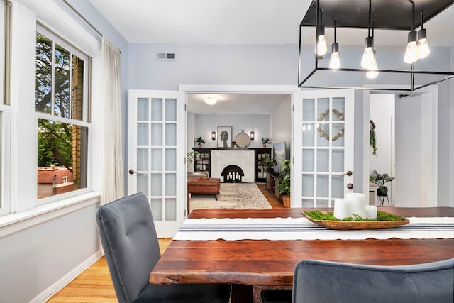 2127 W Pierce Ave Unit 2A, Chicago, IL 60622 - dining area with wood finished floors, a chandelier, and french doors
